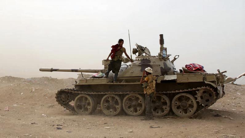 Members of UAE-backed southern Yemeni separatist forces stand by a tank during clashes with government forces in Aden