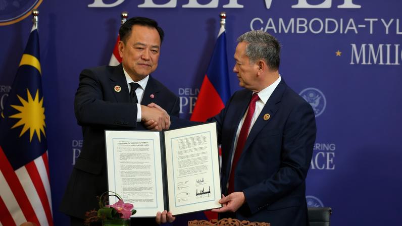 Thailand's Prime Minister Anutin Charnvirakul and Cambodia's Prime Minister Hun Manet shake hands and hold up a document, during the signing of a ceasefire deal between Cambodia and Thailand on the sidelines of the 47th Association of Southeast Asian Nations (ASEAN) summit in Kuala Lumpur, Malaysia, October 26, 2025.