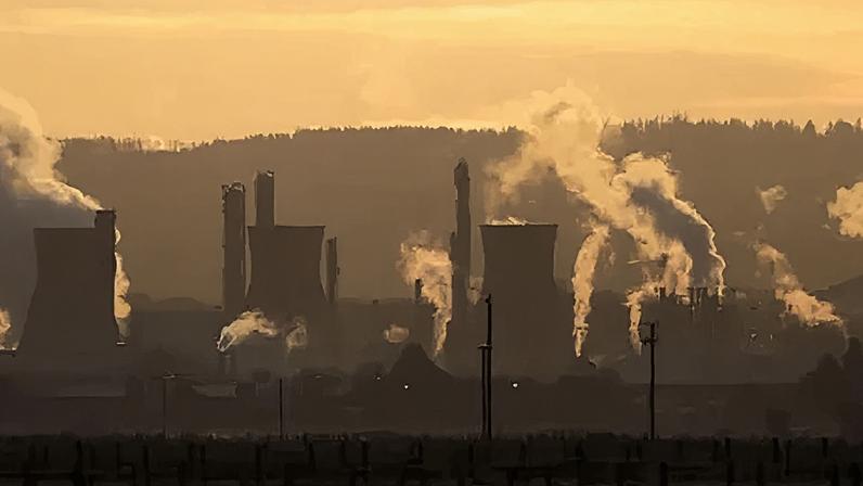 Getty Images A general view of the Grangemouth refinery during a sunset, an orange-tinged sky and the smoke coming from giant industrial towers lit up by the sun
