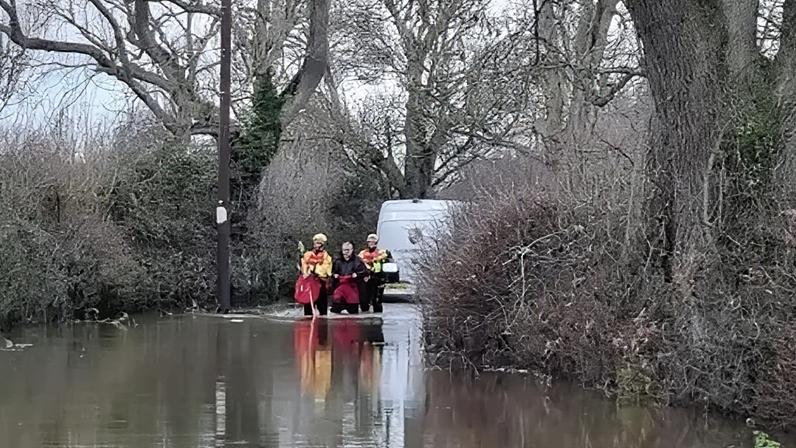 The man was given a protective suit and led to safety