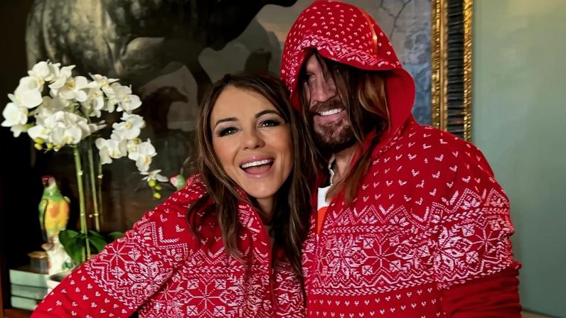 Billy Ray Cyrus and Elizabeth Hurley celebrated their first Christmas together as a couple in matching red onesie pajamas.