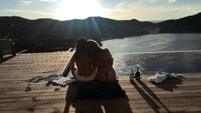 Heidi Klum snuggled up to Tom Kaulitz poolside in nothing but thong bikini bottoms.