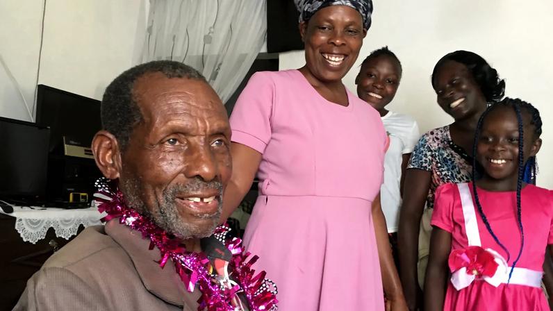 Wafula celebrating his 91st birthday with his daughter and grandchildren in December 2024.