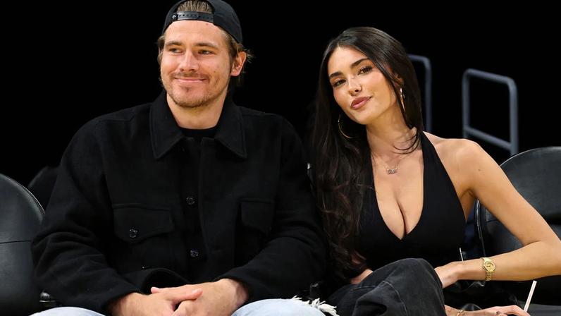 Quarterback Justin Herbert #10 of the Los Angeles Chargers and Madison Beer attend a basketball game between Los Angeles Lakers and Minnesota Timberwolves at Crypto.com Arena on October 24, 2025 in Los Angeles, California.
