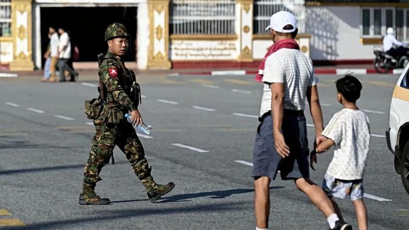 A soldier patrols a street during the first phase of Myanmar's general election in Yangon on Dec. 28.