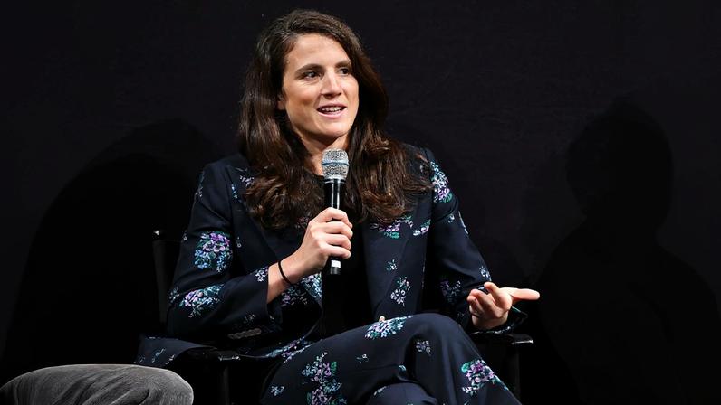 Tatiana Schlossberg speaking into a microphone.