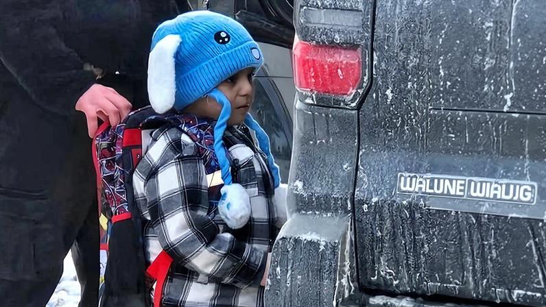 An ICE agent holding onto the backpack of five-year-old Liam Ramos as he is being detained on 20 January 2026 in Minneapolis, Minnesota.