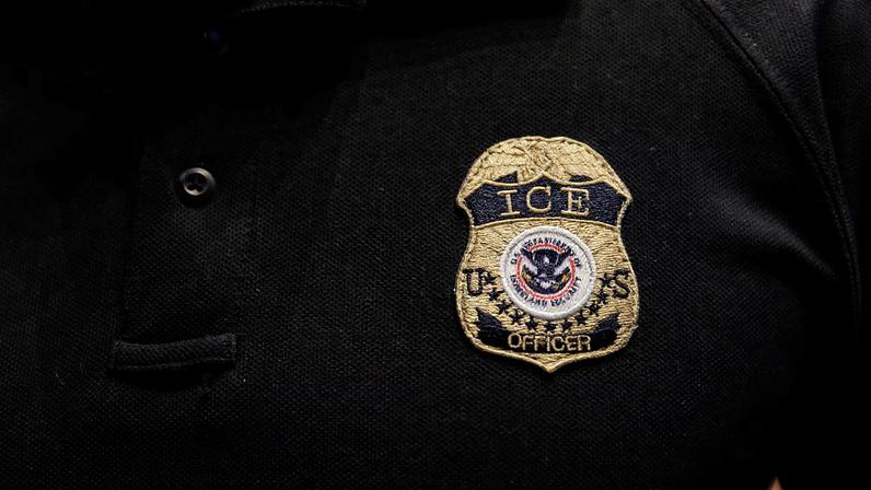 The badge of a U.S. Immigration and Customs Enforcement (ICE) is embroidered on a polo shirt of an ICE employee in Arlington, Texas, U.S. August 26, 2025. REUTERS/Shelby Tauber
