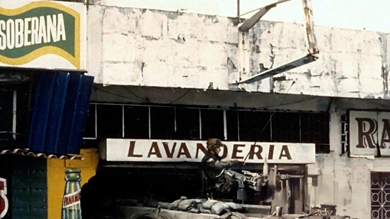 An American M113 armoured personnel carrier on guard outside a laundry in Panama during the second day of Operation Just Cause in December 1989.