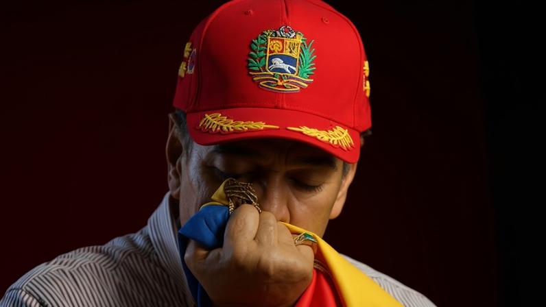 Nicolás Maduro kisses a Venezuelan flag at a ceremony in Caracas, Venezuela, on 1 December.