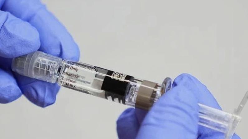 A certified medical assistant holds a syringe for a flu vaccine at a clinic in Seattle, on 10 September 2025.