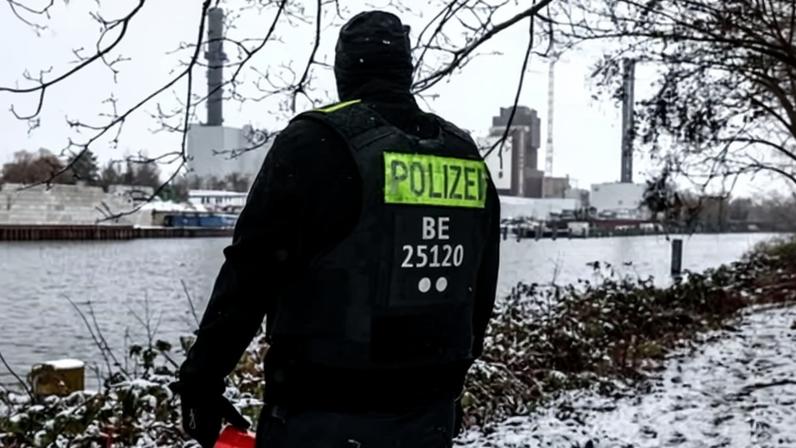 A police officer stands guard in front of the Lichterfelde power plant in south-west Berlin.