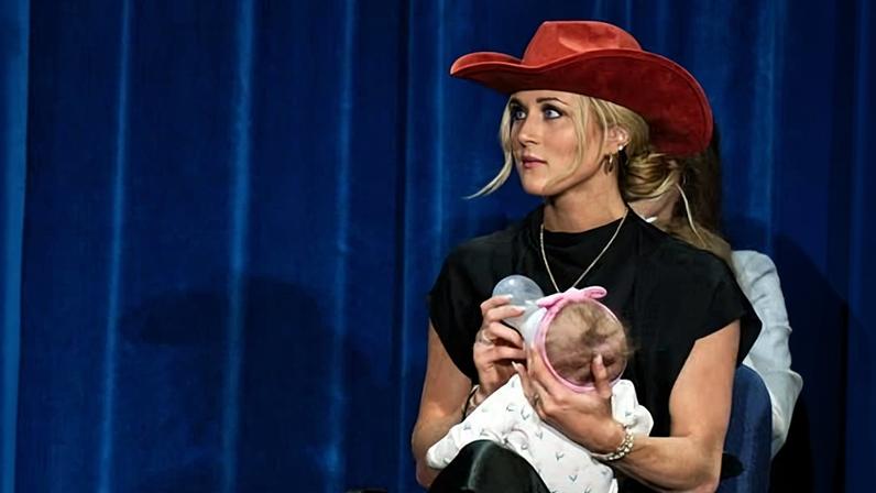 Riley Gaines feeds her baby on stage at a "Policy Celebration" at the US Department of Health and Human Services headquarters in Washington DC on 8 January 2026.