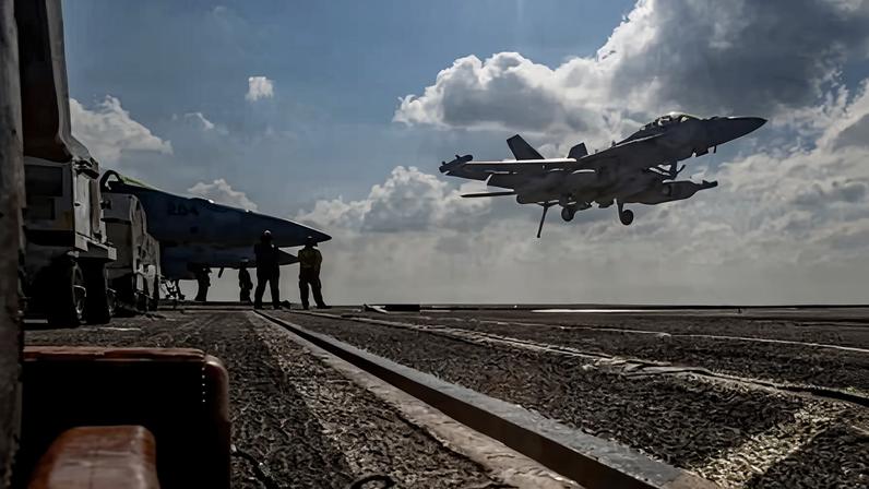 An EA-18G Growler landing on the flight deck of the USS Abraham Lincoln aircraft carrier.