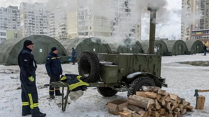 Ukrainian rescue workers deploy tents at a heating point in Kyiv to provide emergency relief amid freezing conditions.