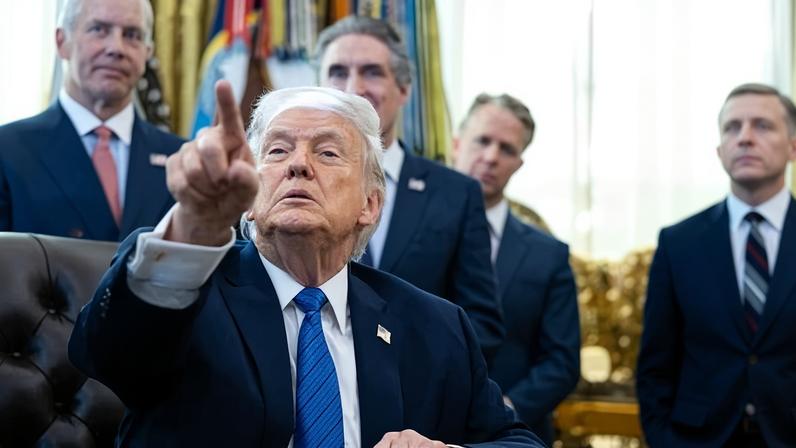Donald Trump signs executive orders in the Oval Office at the White House in Washington DC, on Friday.