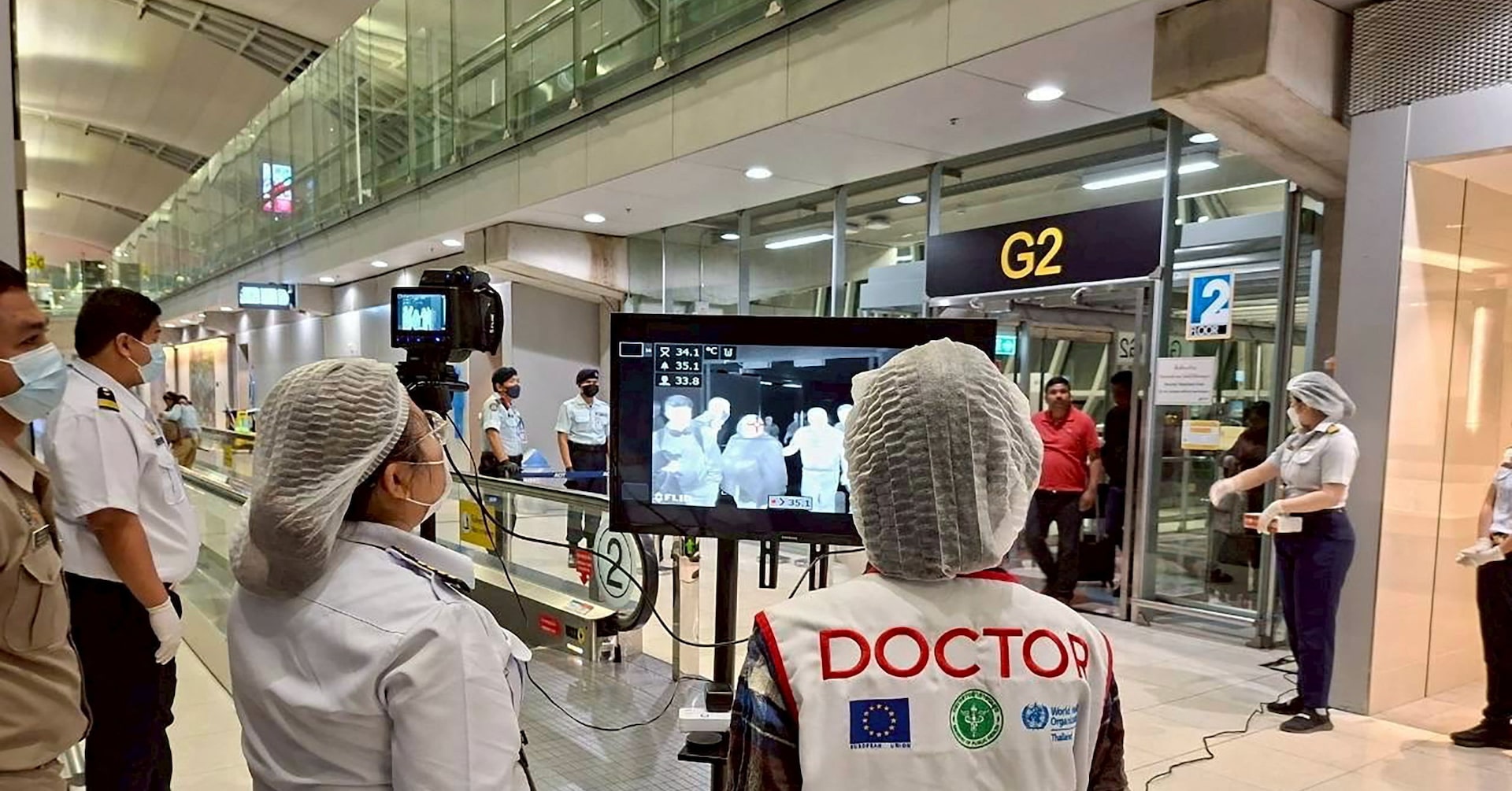 Airport health authorities wearing protective masks monitor passengers from international flights arriving at Suvarnabhumi International Airport in Bangkok, Thailand, January 25, 2026, following the implementation of health screening measures for passengers arriving from West Bengal, India, amid reports of a Nipah virus outbreak.