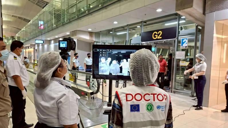 Airport health authorities wearing protective masks monitor passengers from international flights arriving at Suvarnabhumi International Airport in Bangkok, Thailand, January 25, 2026, following the implementation of health screening measures for passengers arriving from West Bengal, India, amid reports of a Nipah virus outbreak.