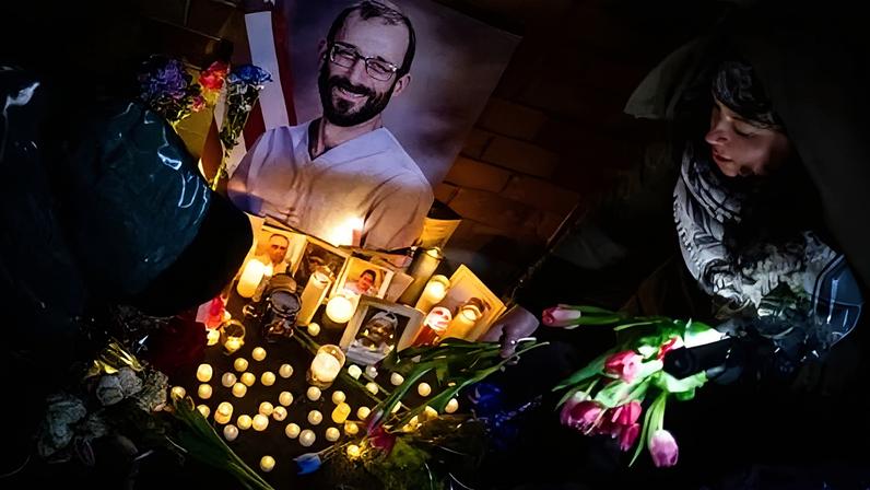 People place flowers at a makeshift memorial for Alex Pretti outside the VA NY Harbor Healthcare System in New York.