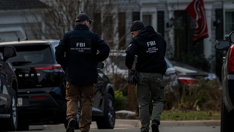FBI agents gather in front of the home of the suspected 6 January pipe bomber in Woodbridge, Virginia, in December.