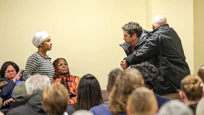 A man is detained by security after charging at congresswoman Ilhan Omar and spraying her with a liquid during a town hall event in Minneapolis, Minnesota, on 27 January 2026.