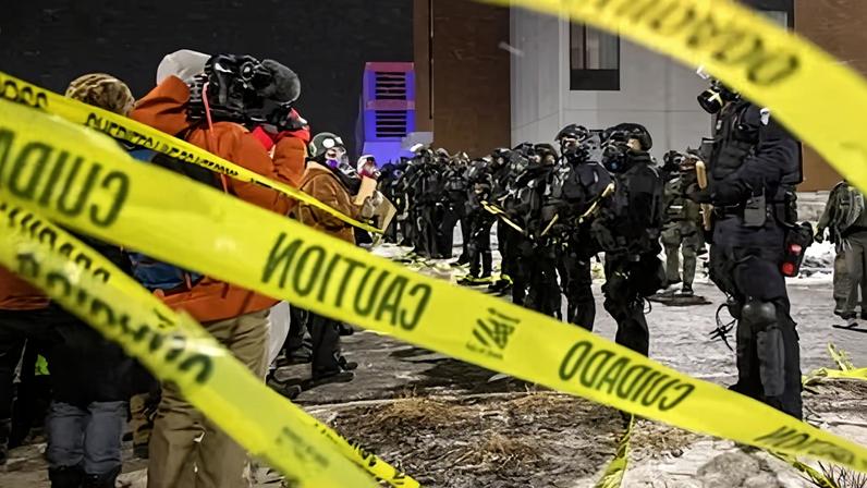 Law enforcement outside a hotel believed to be housing federal immigration agents near Minneapolis, Minnesota, on 26 January 2025.
