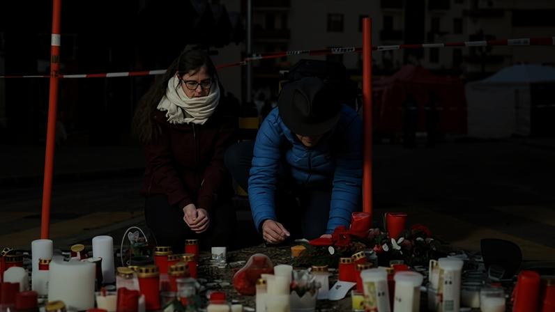 Mourners outside Le Constellation bar, where about 40 people died in a fire early on 1 January.