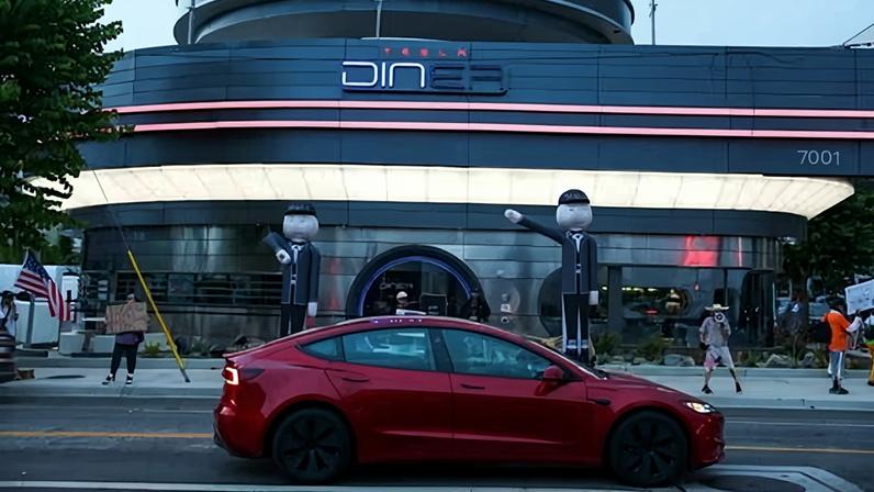 Inflatable tube men depicting Elon Musk are displayed during the ‘Tyrant Diner’ protest, calling for a boycott of Tesla, outside the Tesla Diner in LA.