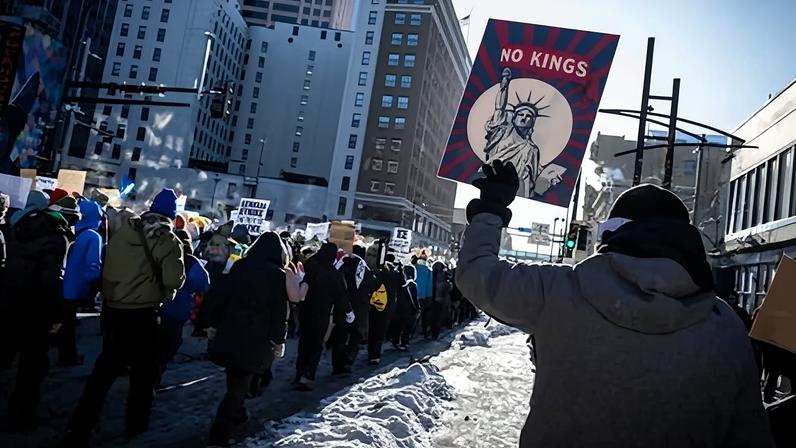 A person holds a ‘No Kings’ sign during a protest against ICE in Minneapolis, Minnesota, on 23 January 2026.