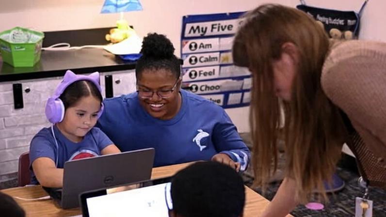 An aspiring educator works with a teaching mentor during a first graders' reading class at Ponderosa elementary school in Aurora, Colorado, on 29 October 2024.