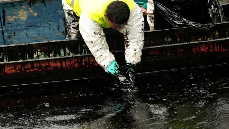 State oil company workers clean up the Viche River in Ecuador’s Esmeraldas province on March 15, 2025, after an oil spill triggered by a mudslide that fractured a pipeline.