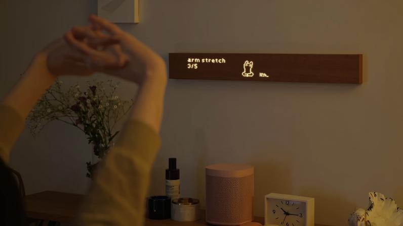 A person stretching in front of a Mui Board.