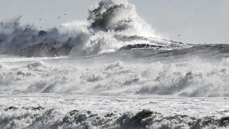 A Pacific Ocean wave crashes against a jetty as waves roll toward the shore in Ventura, California, on Dec. 30, 2023.