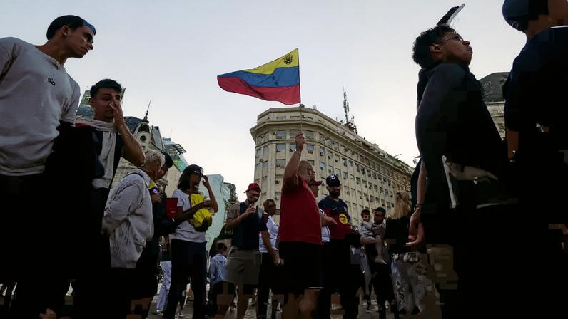 A person holds a Venezuelan flag during a protest for a democratic transition in Venezuela, after the U.S. launched strikes on the country, capturing President Nicolas Maduro and his wife, Cilia Flores, in Buenos Aires, Argentina, January 4, 2026. REUTERS/Mariana Nedelcu