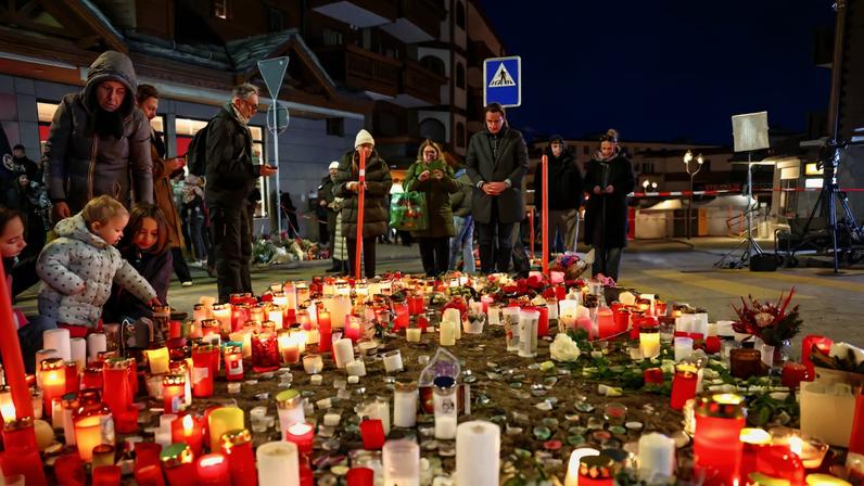 People gather by a makeshift memorial near the "Le Constellation" bar, after a fire and explosion during a New Year's Eve party in which people died and others were injured, in the upscale ski resort of Crans-Montana in southwestern Switzerland, January 2, 2026. REUTERS/Denis Balibouse