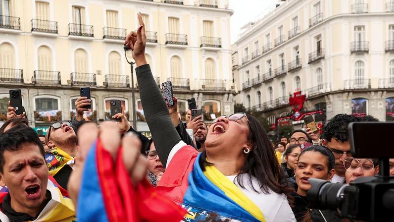 People react to the news of U.S. strikes on Venezuela and capture of President Maduro, in Madrid