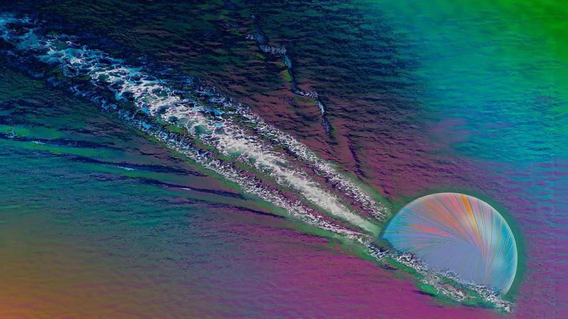 A spherical quark creates a wake as it flows through colorful liquid. “Studying how quark wakes bounce back and forth will give us new insights on the quark-gluon plasma’s properties,” Yen-Jie Lee says.