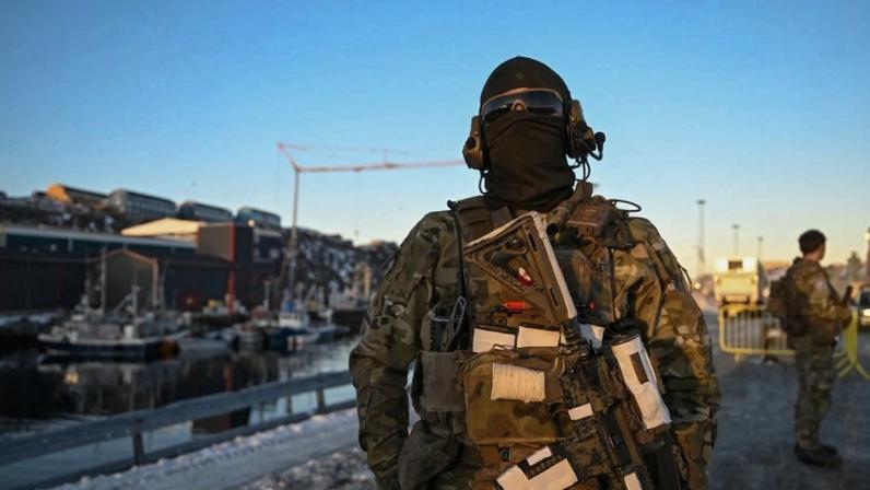 A Danish soldier stands at a checkpoint in the harbor of Nuuk, Greenland, on Jan. 26.