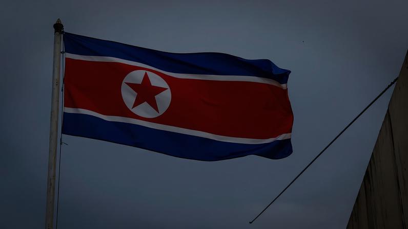 The North Korea flag flutters next to concertina wire at the North Korean embassy in Kuala Lumpur