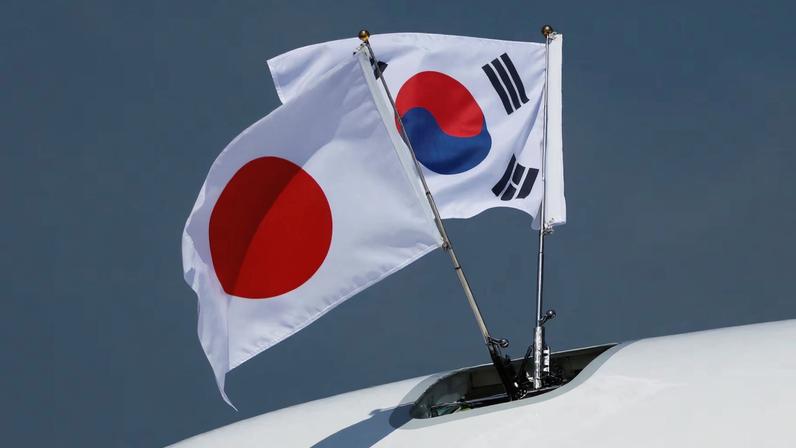 A view of South Korean and Japanese national flags on the airplane carrying South Korea's President Yoon Suk Yeol and his wife Kim Keon-hee, at Tokyo International Airport (Haneda Airport) in Tokyo, Japan March 16, 2023. REUTERS/Issei Kato