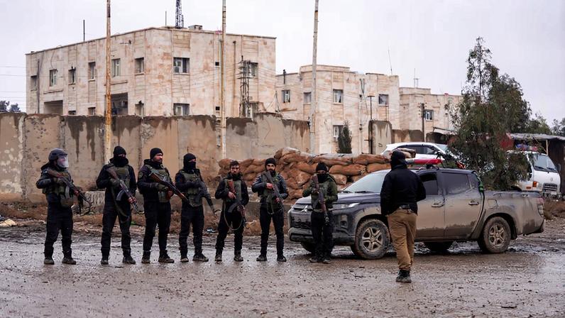 Syrian security forces outside al-Aqtan prison, where some Islamic State detainees are held, in Raqqa