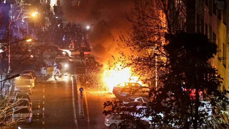 Cars burn in a street during a protest over the collapse of the currency's value, in Tehran, Iran, January 8, 2026. Stringer/WANA (West Asia News Agency) via REUTERS