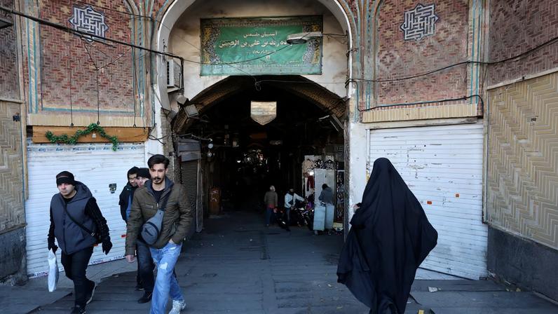 People walk past closed shops following protests over a plunge in the currency's value, in the Tehran Grand Bazaar in Tehran, Iran, December 30, 2025. Majid Asgaripour/WANA (West Asia News Agency) via REUTERS
