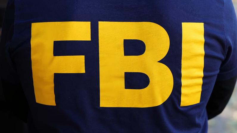 An FBI logo is pictured on an agent's shirt during the U.S. law enforcements raid on Russian oligarch Oleg Deripaska's property in the Manhattan borough of New York City, New York, U.S. October 19, 2021. REUTERS/Carlo Allegri