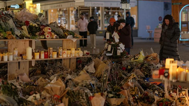 People visit a makeshift memorial outside the "Le Constellation" bar, after a deadly fire and explosion during a New Year's Eve party in the upscale ski resort of Crans-Montana in southwestern Switzerland, January 4, 2026.