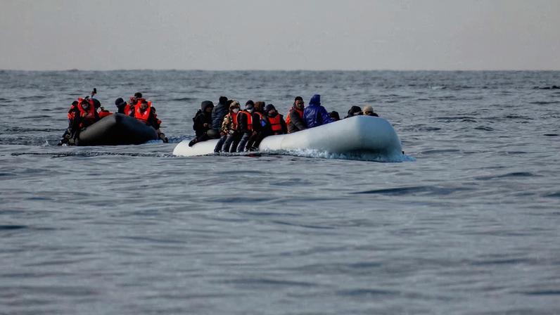 Migrants cross the English Channel in small boats