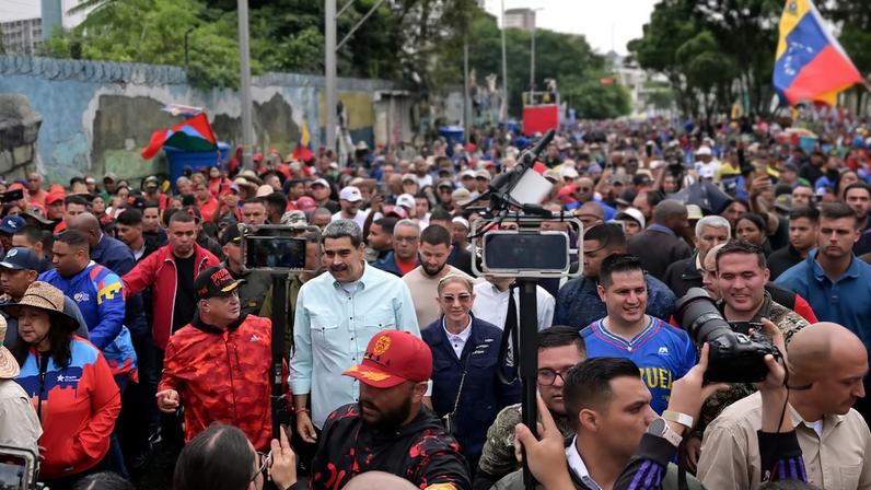 Venezuela's President Nicolas Maduro, walks with first lady Cilia Flores and Interior Minister Diosdado Cabello, as he joins his supporters during a march to commemorate the Battle of Santa Ines, on the same day Venezuelan opposition leader Maria Corina Machado was awarded the 2025 Nobel Peace Prize in Norway, in Caracas, Venezuela, December 10, 2025. REUTERS/Gaby Oraa/File Photo