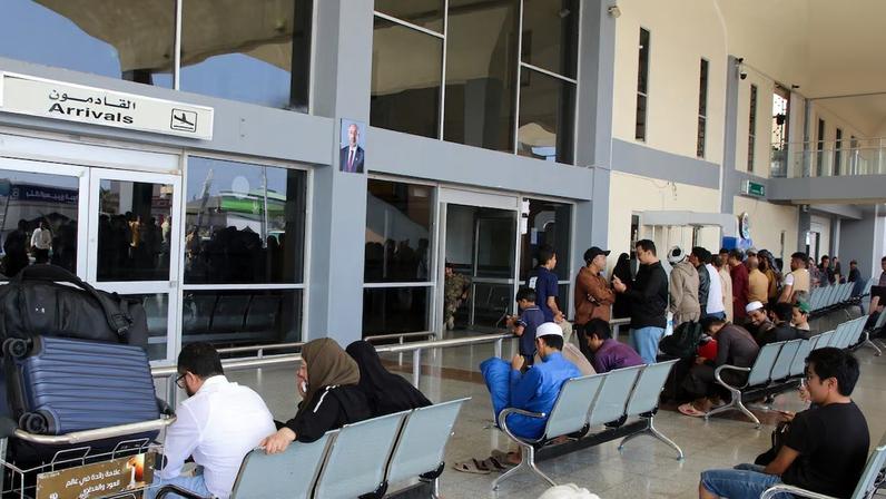 Passengers wait for their flights at Aden Airport in Aden
