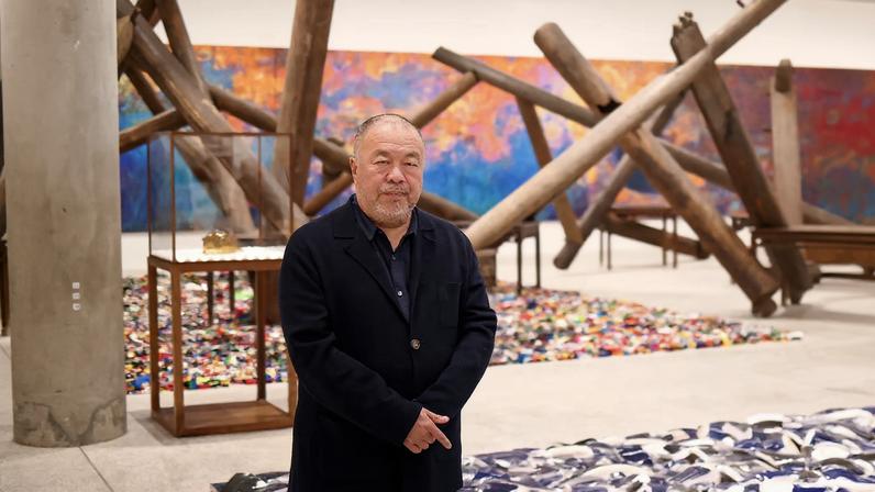 Chinese artist Ai Weiwei poses during a photocall, amongst art pieces displayed in his exhibition "Ai Weiwei: making sense" at the Design Museum in London, Britain, April 4, 2023.