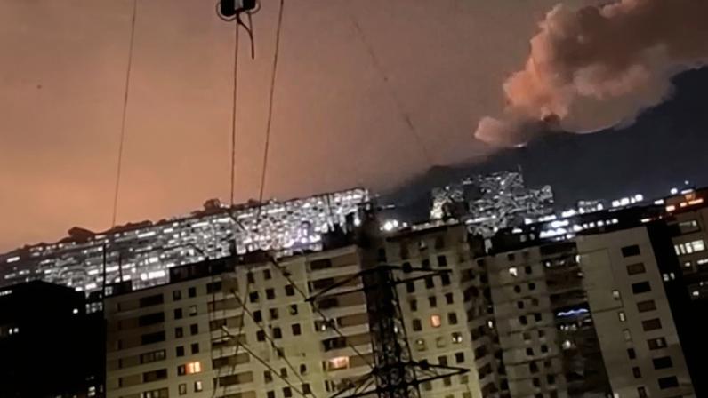 A column of smoke rises following an explosion, as the sky is illuminated by another explosion in the distance in the early hours of the morning, in Caracas, Venezuela, January 3, 2026 in this screen grab obtained from video obtained by Reuters.